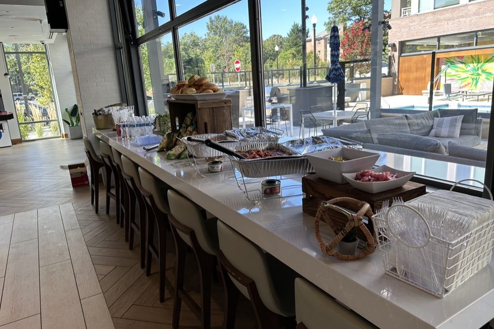 Buffet service set up in a residential community lounge for a resident event by B Hospitality Group